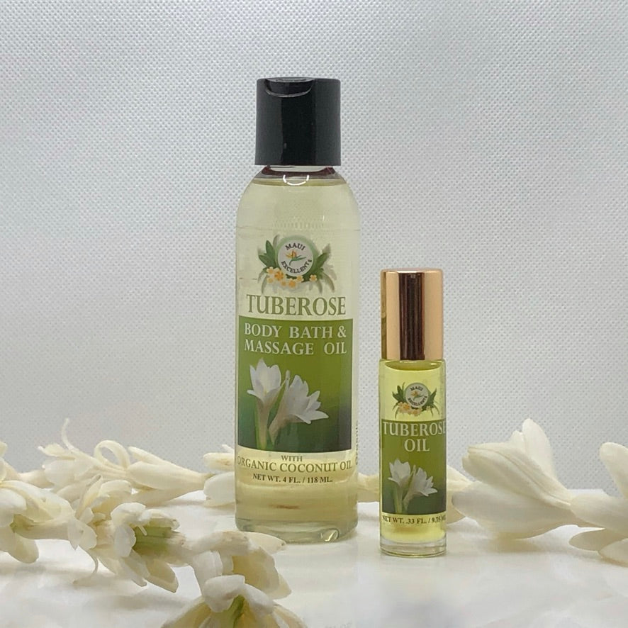 Maui Excellent Tuberose Body Oil and Tuberose Roll-On Oil with a tuberose flower lei draped near.